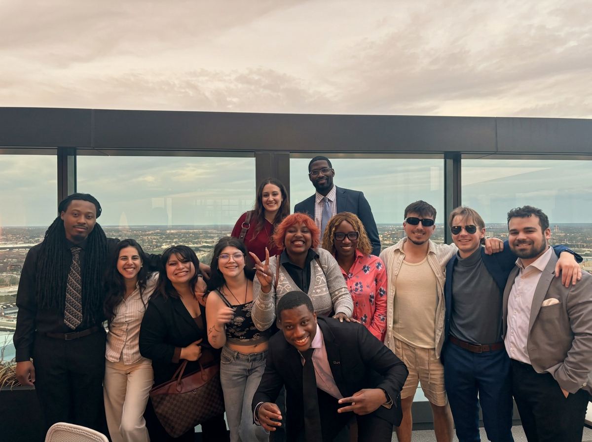 Team gathered on a rooftop overlooking the Columbus skyline