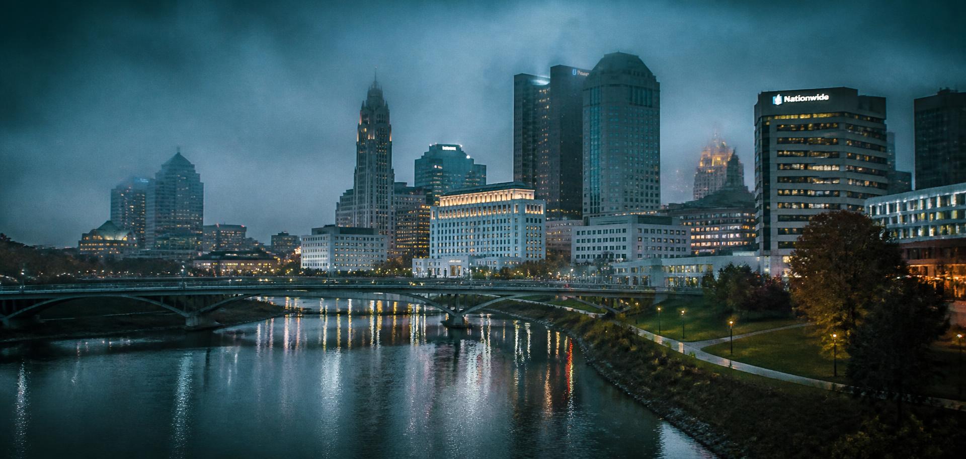 The Columbus, Ohio skyline at blue hour reflected in the Scioto River